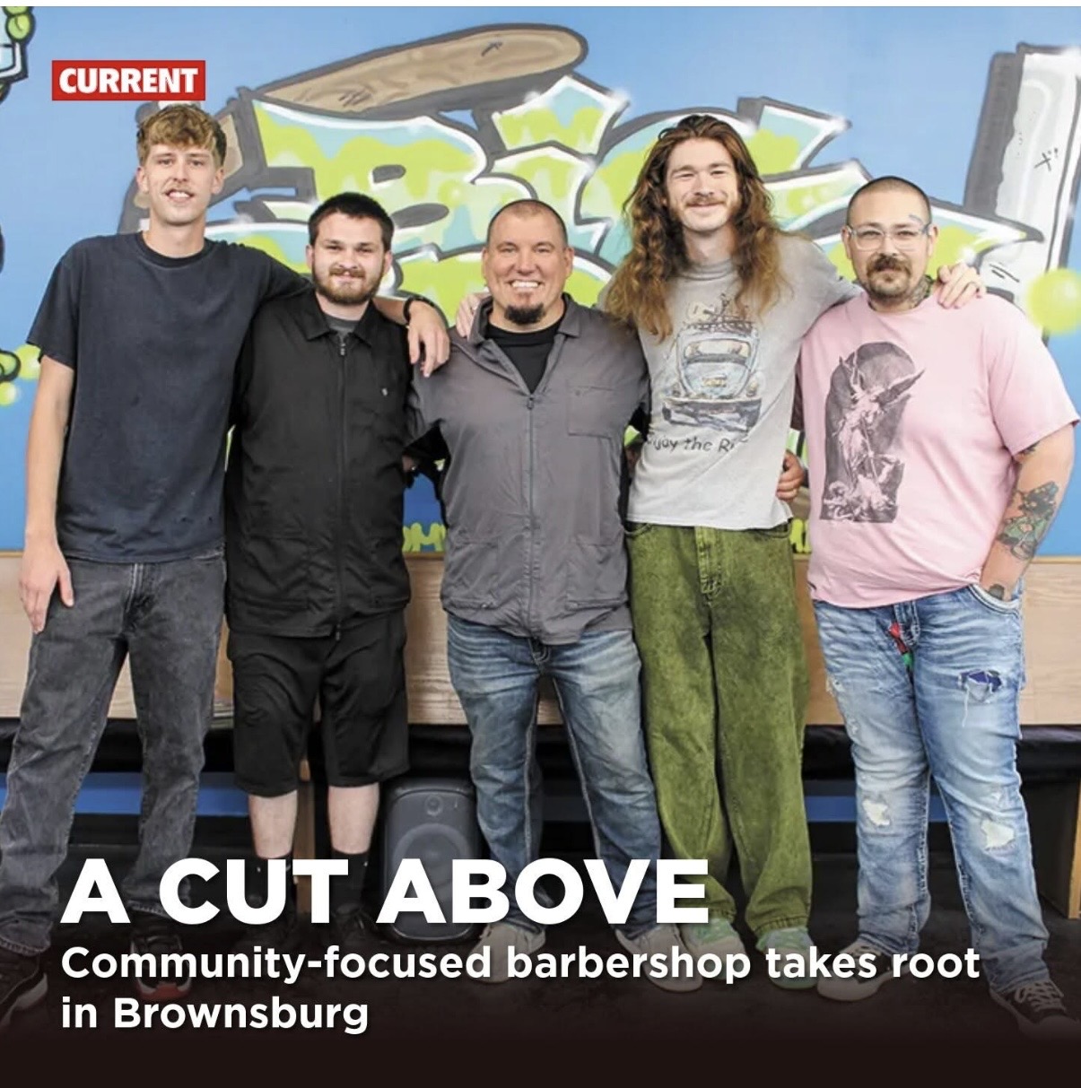 The Big Bros Barbershop team: Blake, Josh, Dave, Kaleb, and Makain standing together in front of the shop's graffiti mural